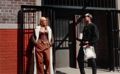 a man and a woman standing in front of a gate