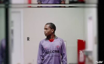 a man standing in front of a mirror in a room