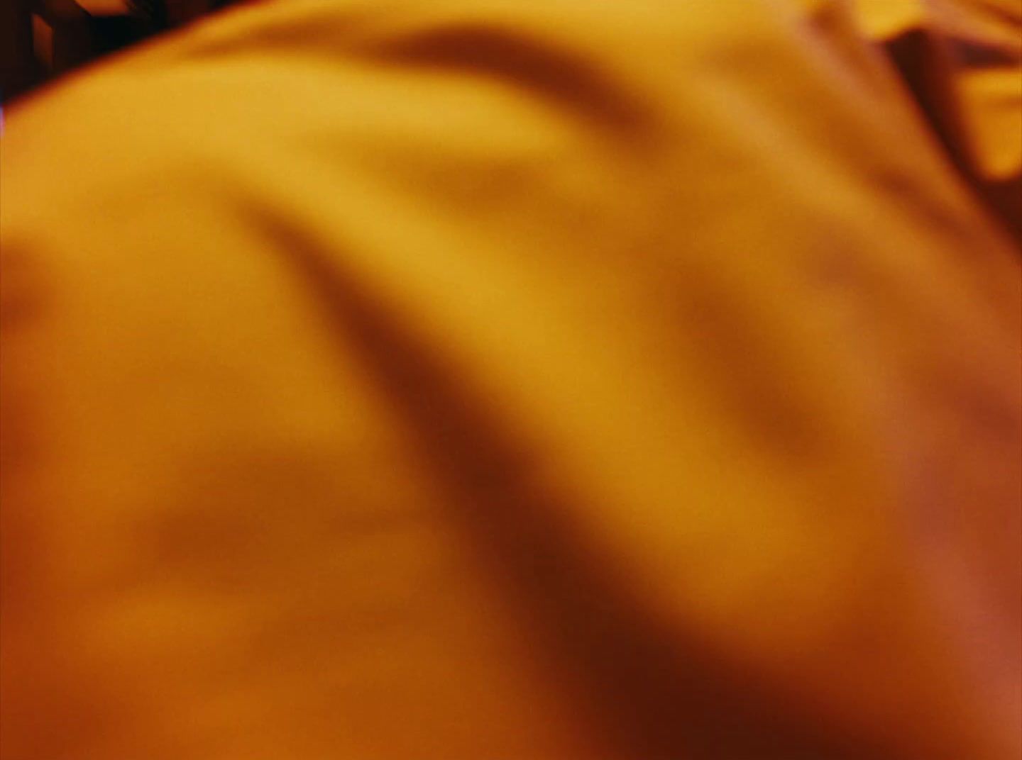 a close up of a person wearing a yellow shirt