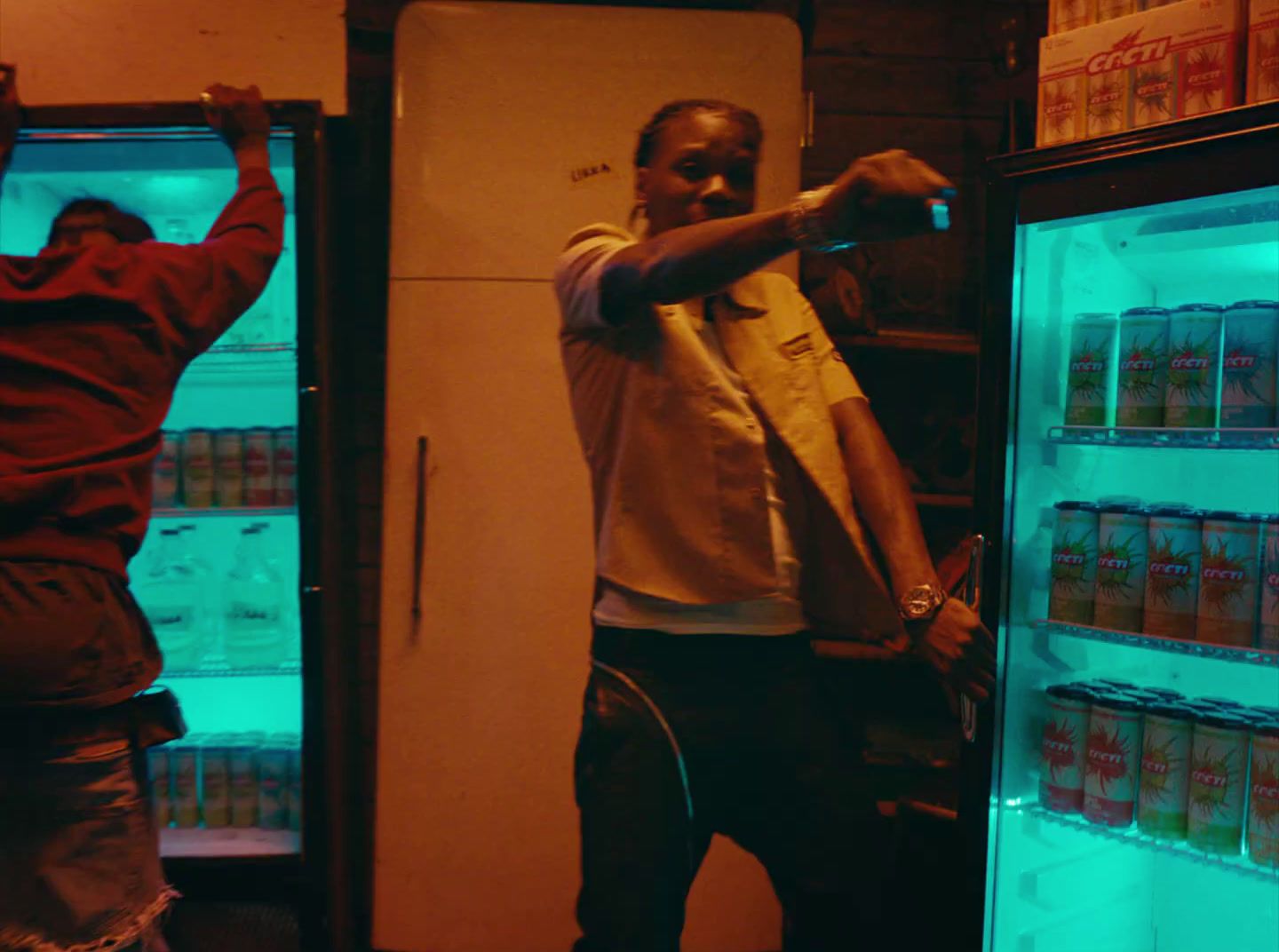 two men are standing in front of a refrigerator