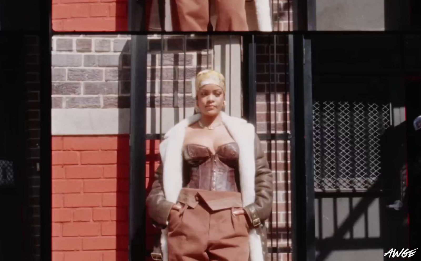 a woman standing in front of a brick building