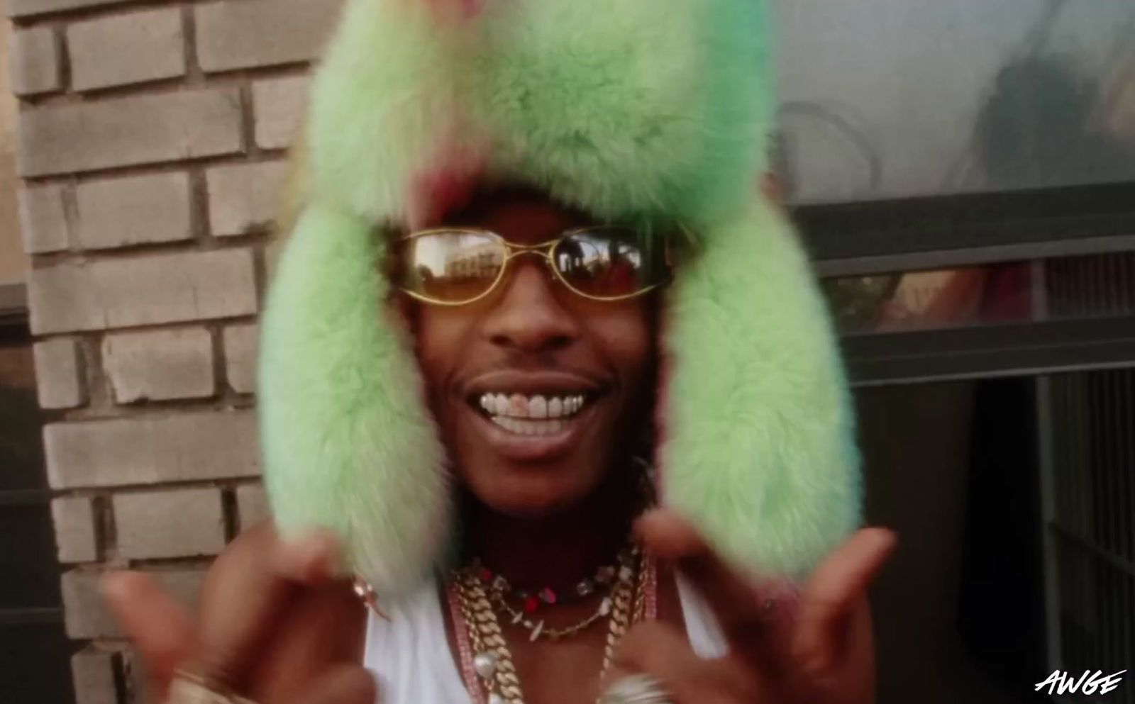 a person wearing a green furry hat and glasses