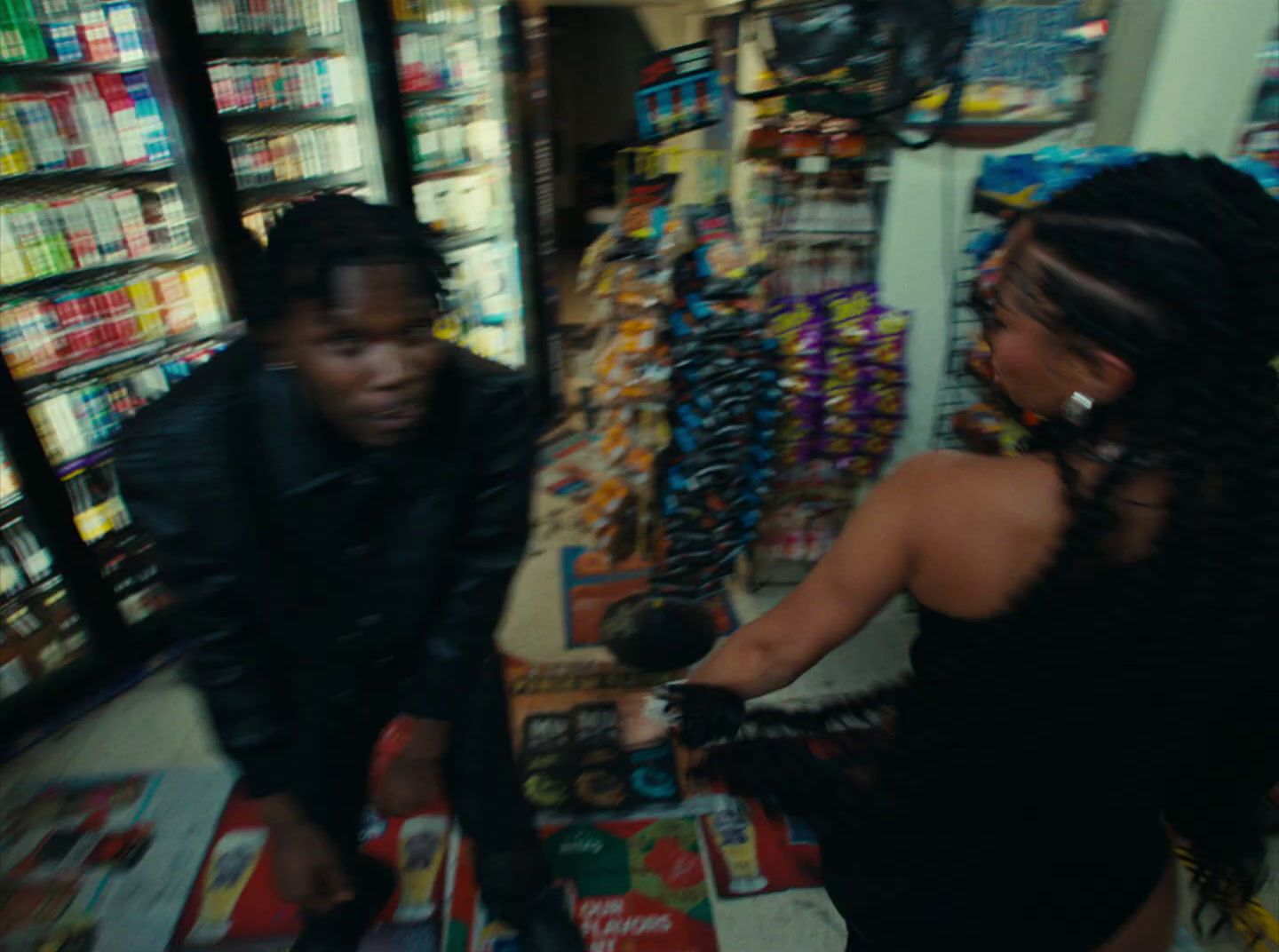 a woman in a black dress standing next to a man in a store