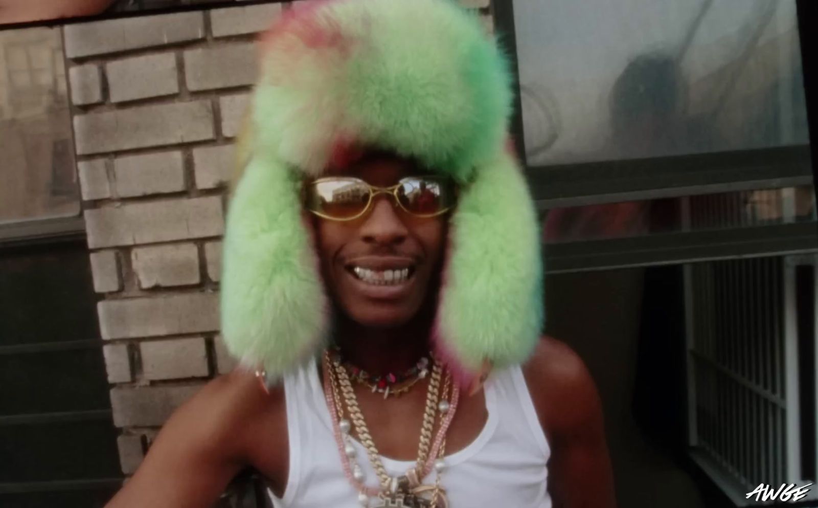 a man wearing a green furry hat and sunglasses