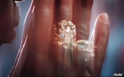 a close up of a person holding a ring