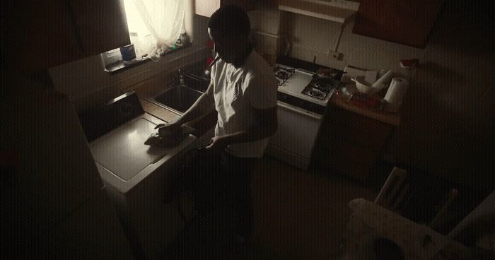 a man standing in a kitchen preparing food