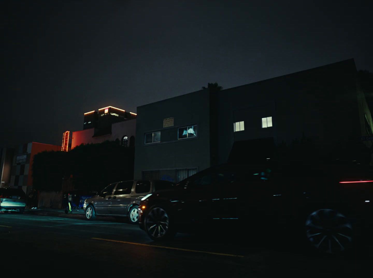 a couple of cars parked in front of a building