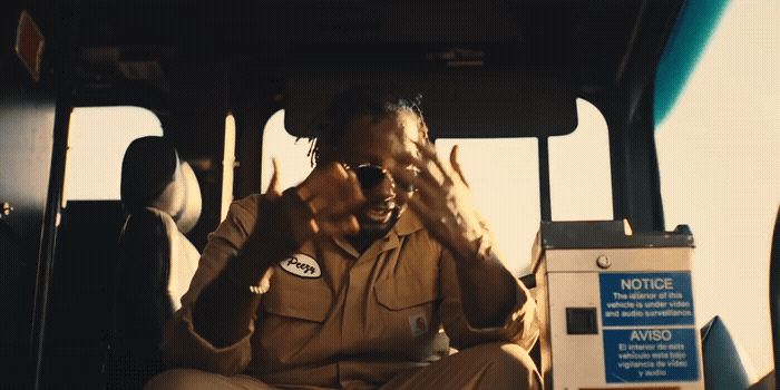 a man sitting in the back of a bus talking on a cell phone