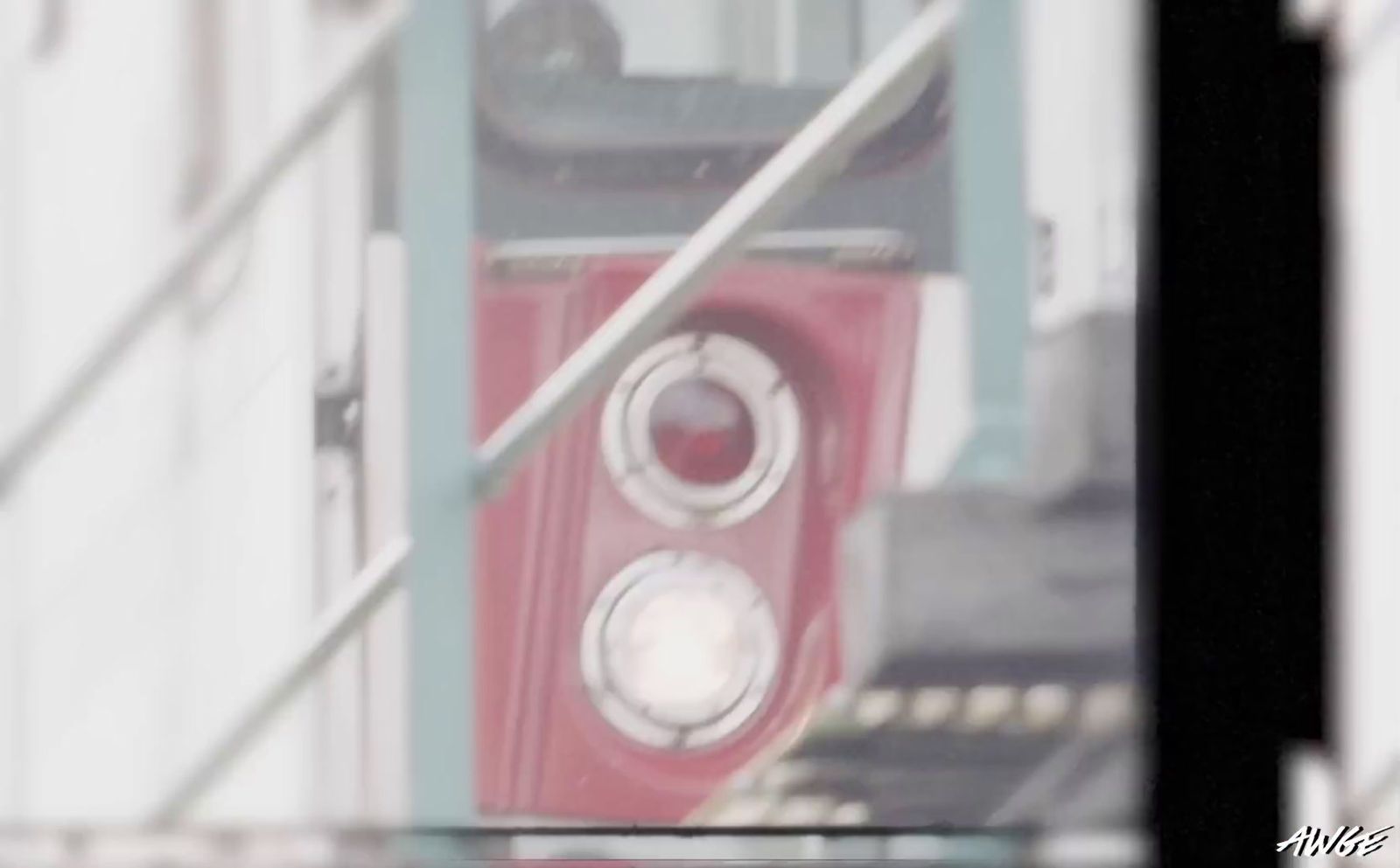 a red speaker sitting on top of a metal pole