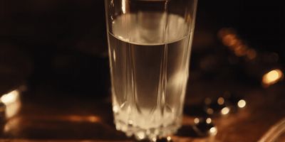 a glass of water sitting on top of a table