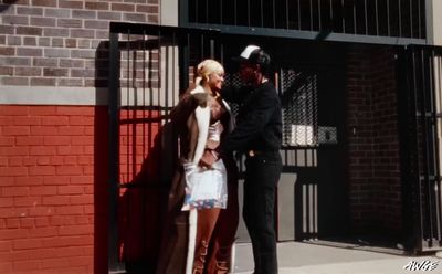 a couple of people that are standing in front of a gate