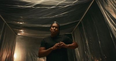 a man standing in a room covered in plastic