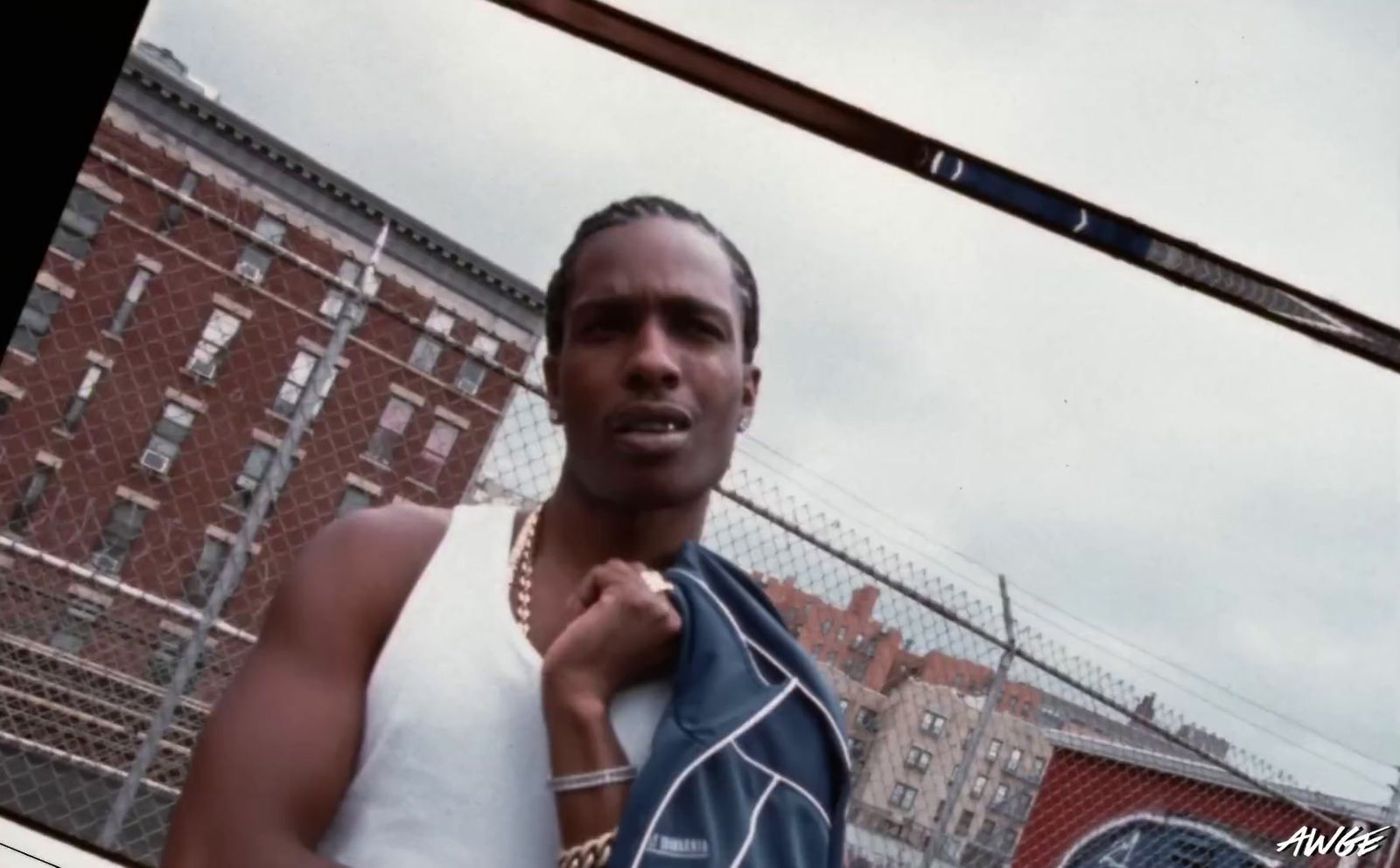 a man standing in front of a chain link fence