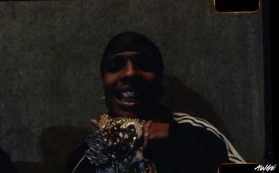 a man holding up a pair of gold rings