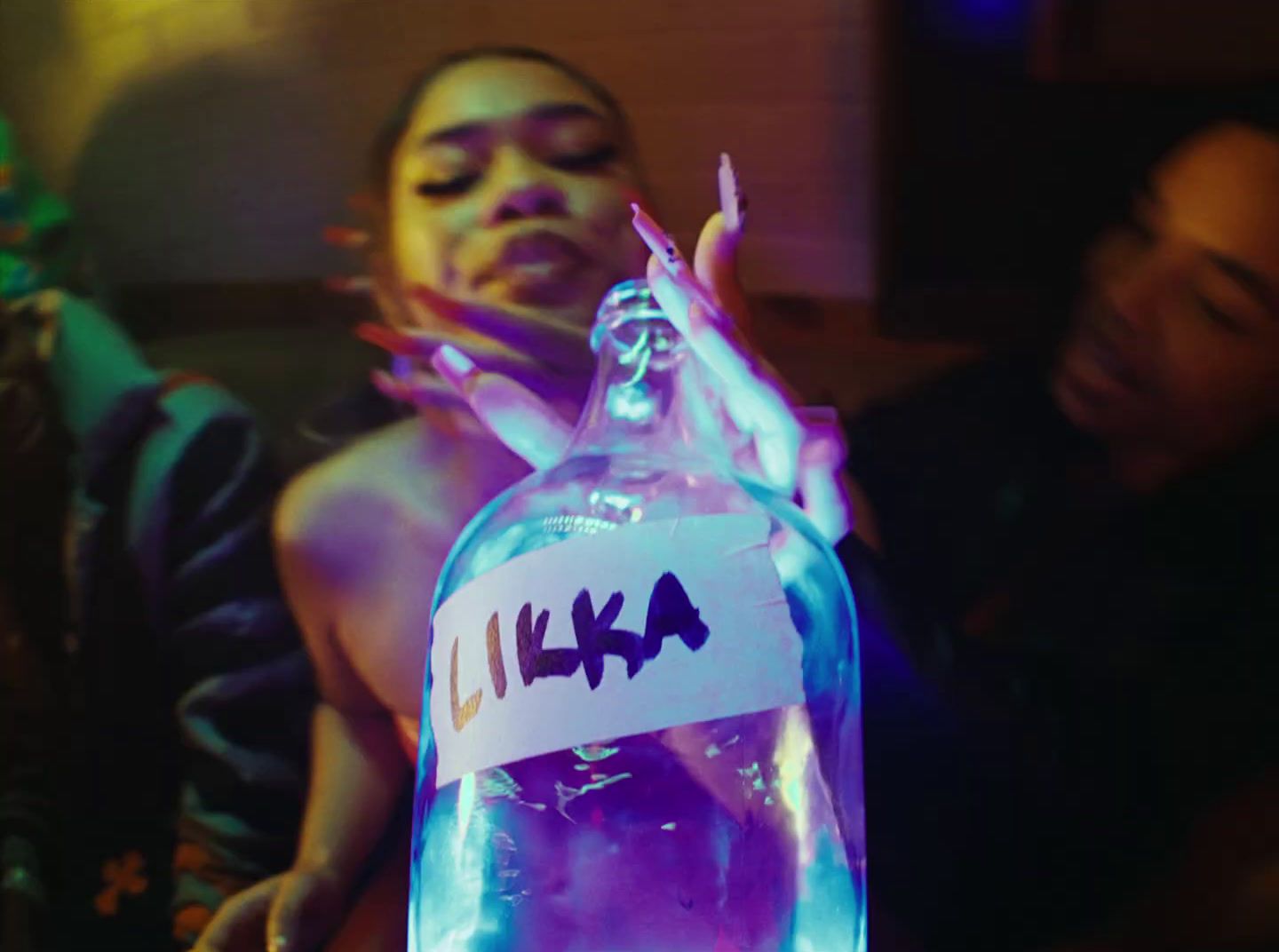 a person holding a bottle with a name on it