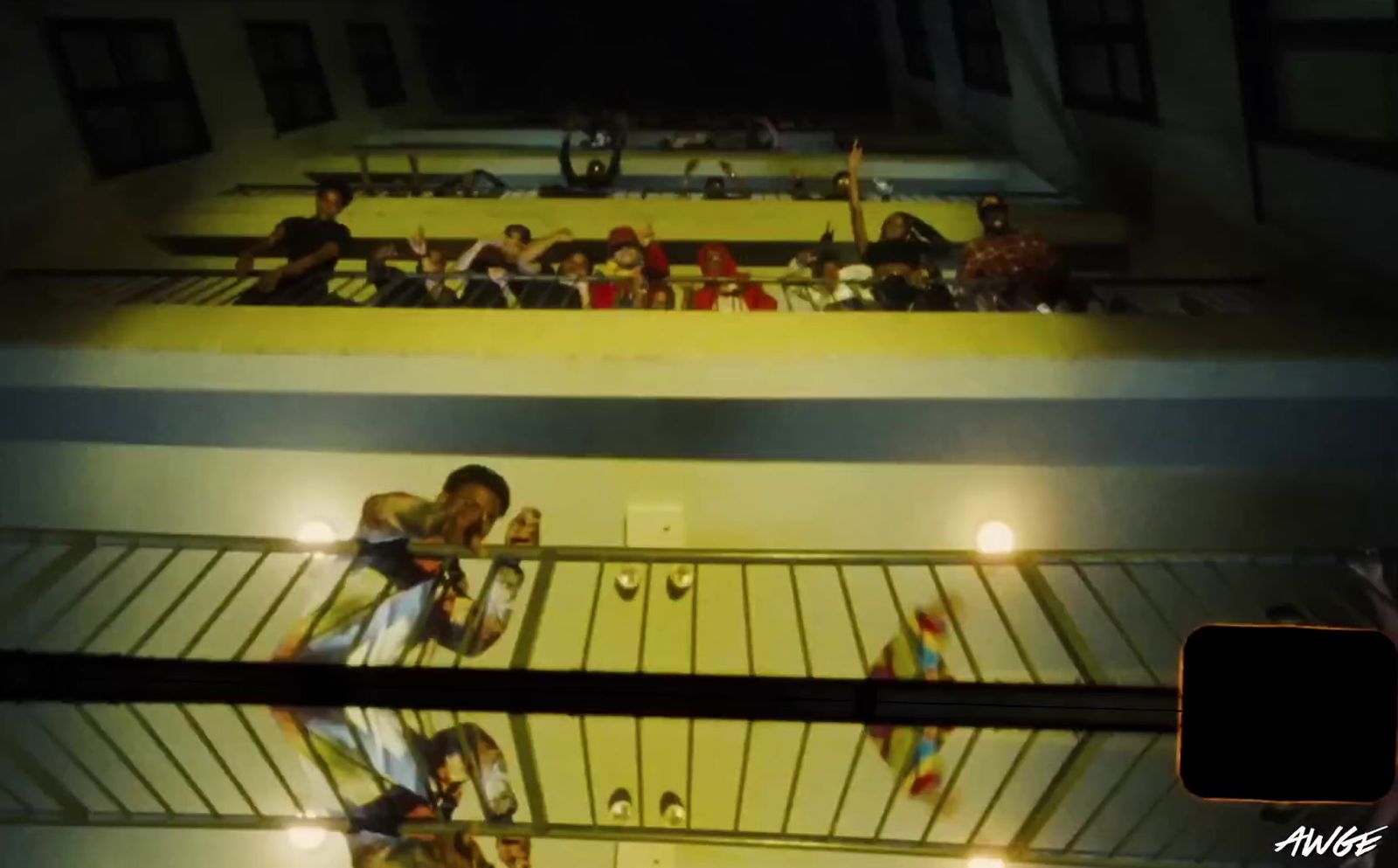 a group of people standing on top of a balcony