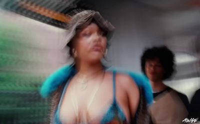 a blurry photo of a woman in a blue bikini