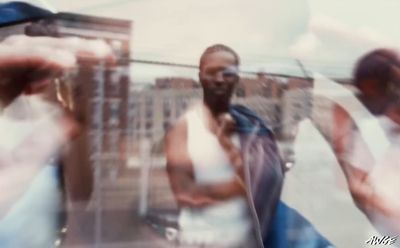 a blurry image of a man holding a cell phone