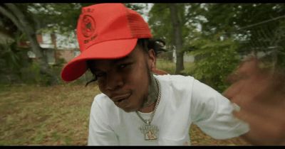 a man wearing a red hat and a white shirt