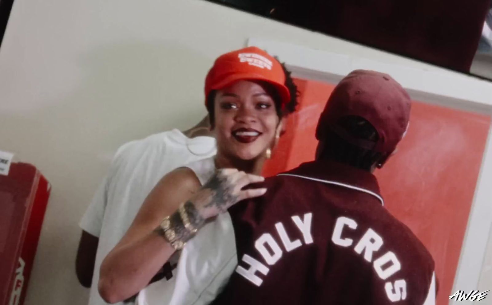 a woman in a baseball cap is talking to a man