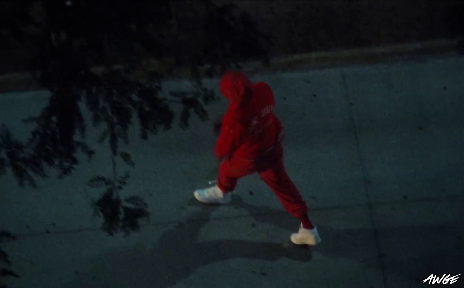 a person in a red suit is walking down the street