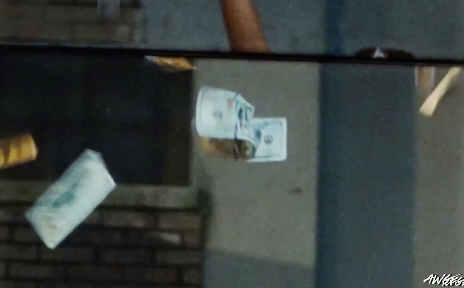 a reflection of a person holding a cigarette and money