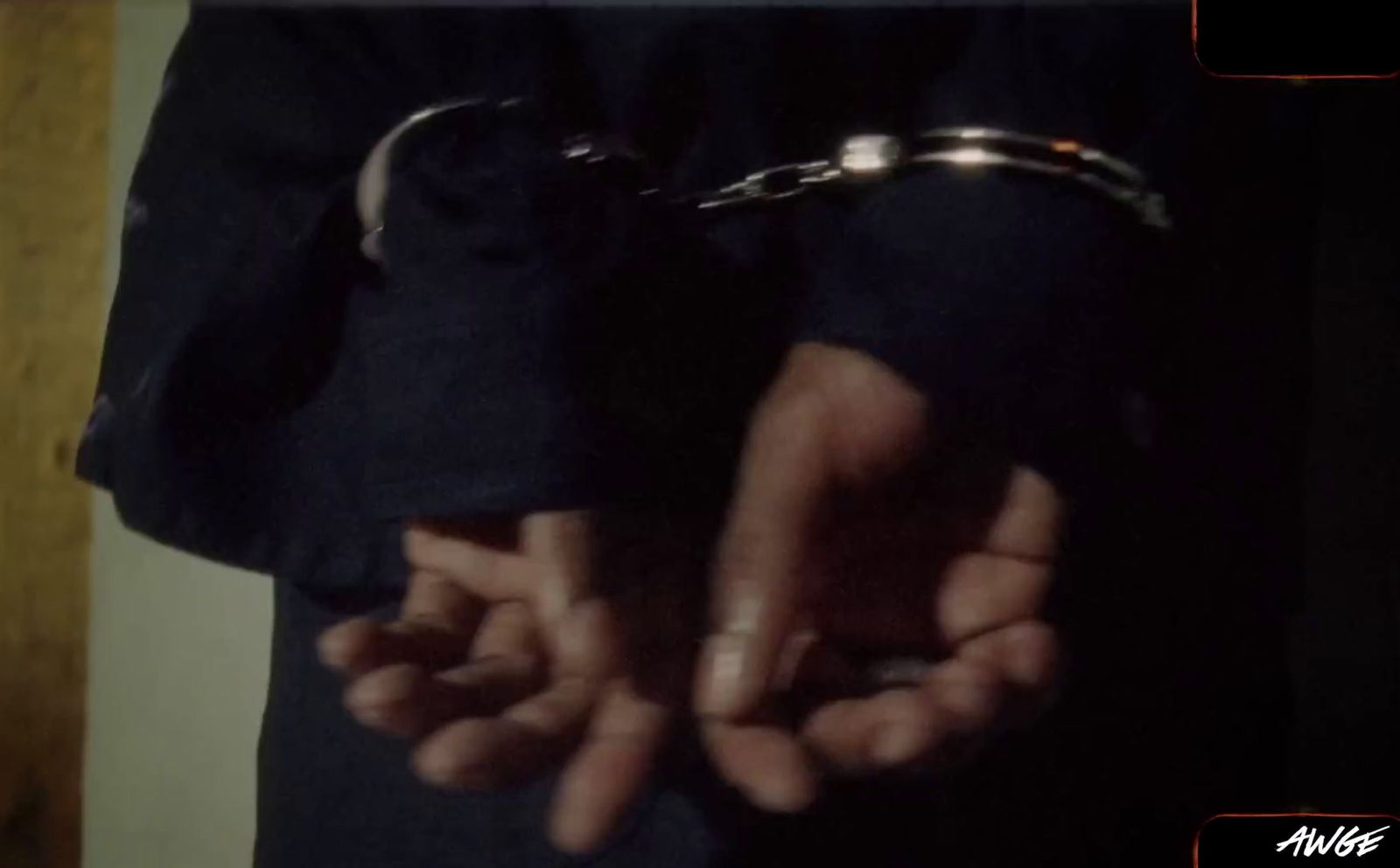 a person is holding their hands in handcuffs