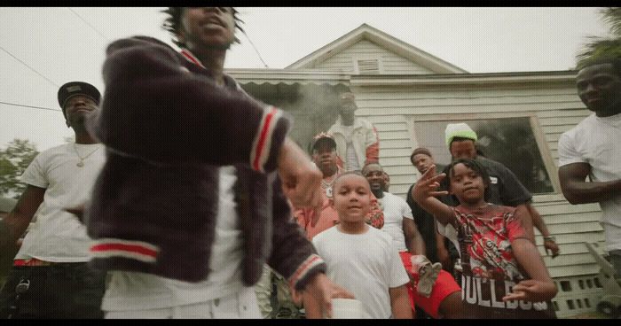 a group of people standing in front of a house