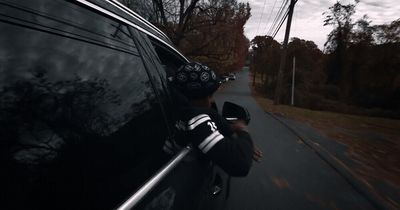 a person leaning out the window of a car