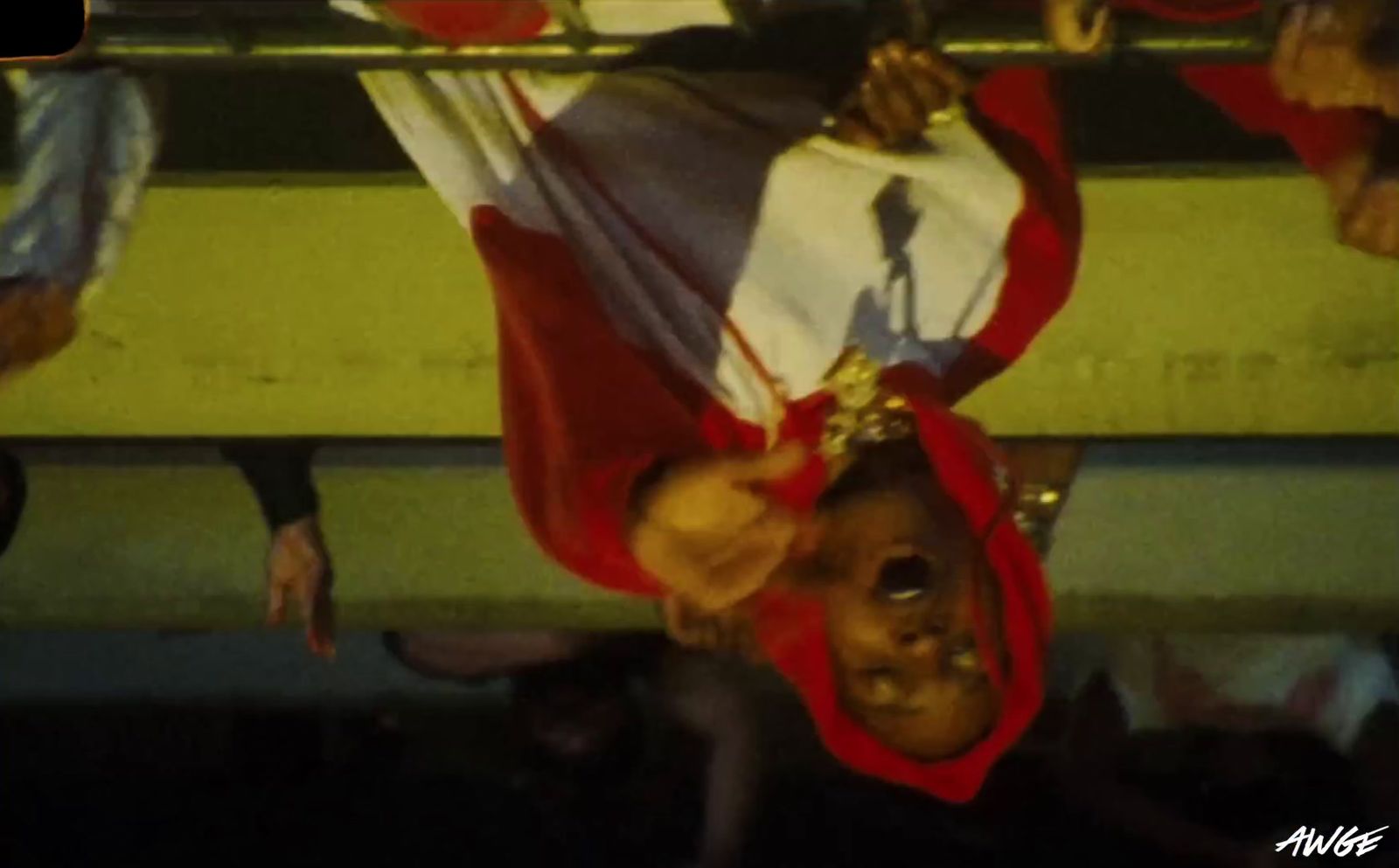 a man with a flag on his head hanging upside down