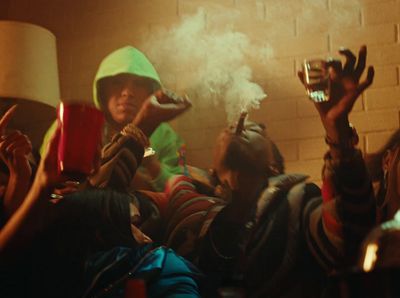 a group of people in a room with smoke coming out of their mouths