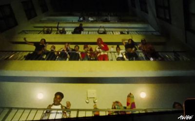 a group of people standing on top of a balcony