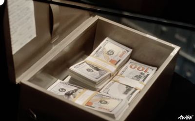 a box filled with lots of money sitting on top of a table