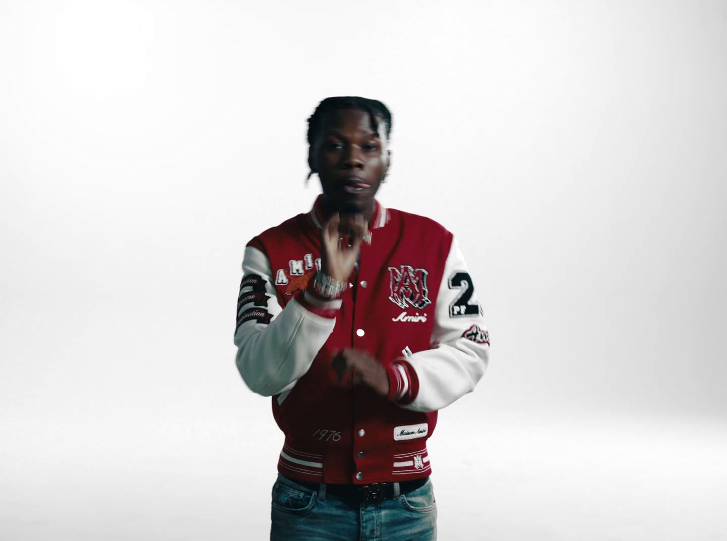 a man in a red and white jacket standing in front of a white background