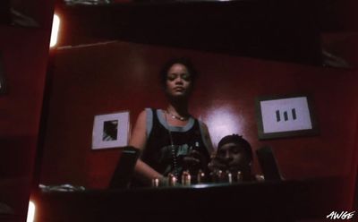 a woman standing in front of a table filled with candles