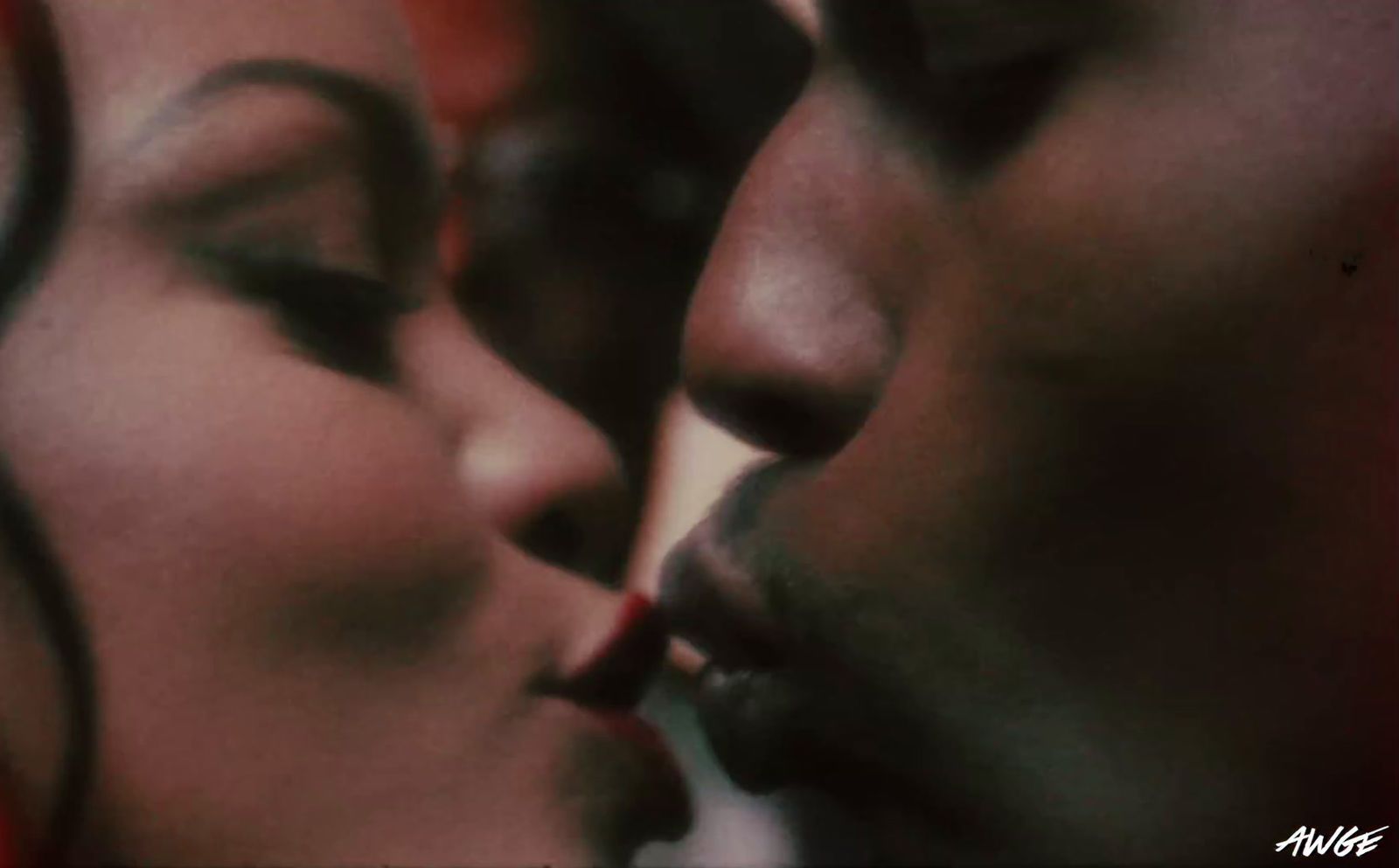 a close up of two people kissing each other