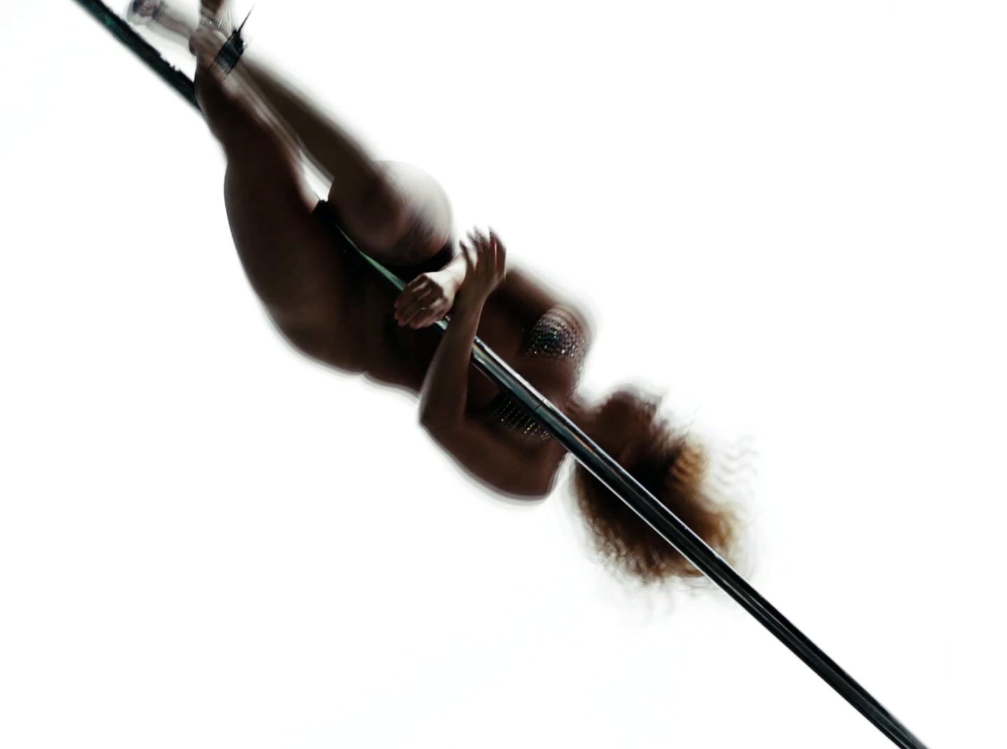 a naked woman holding a pole in the air