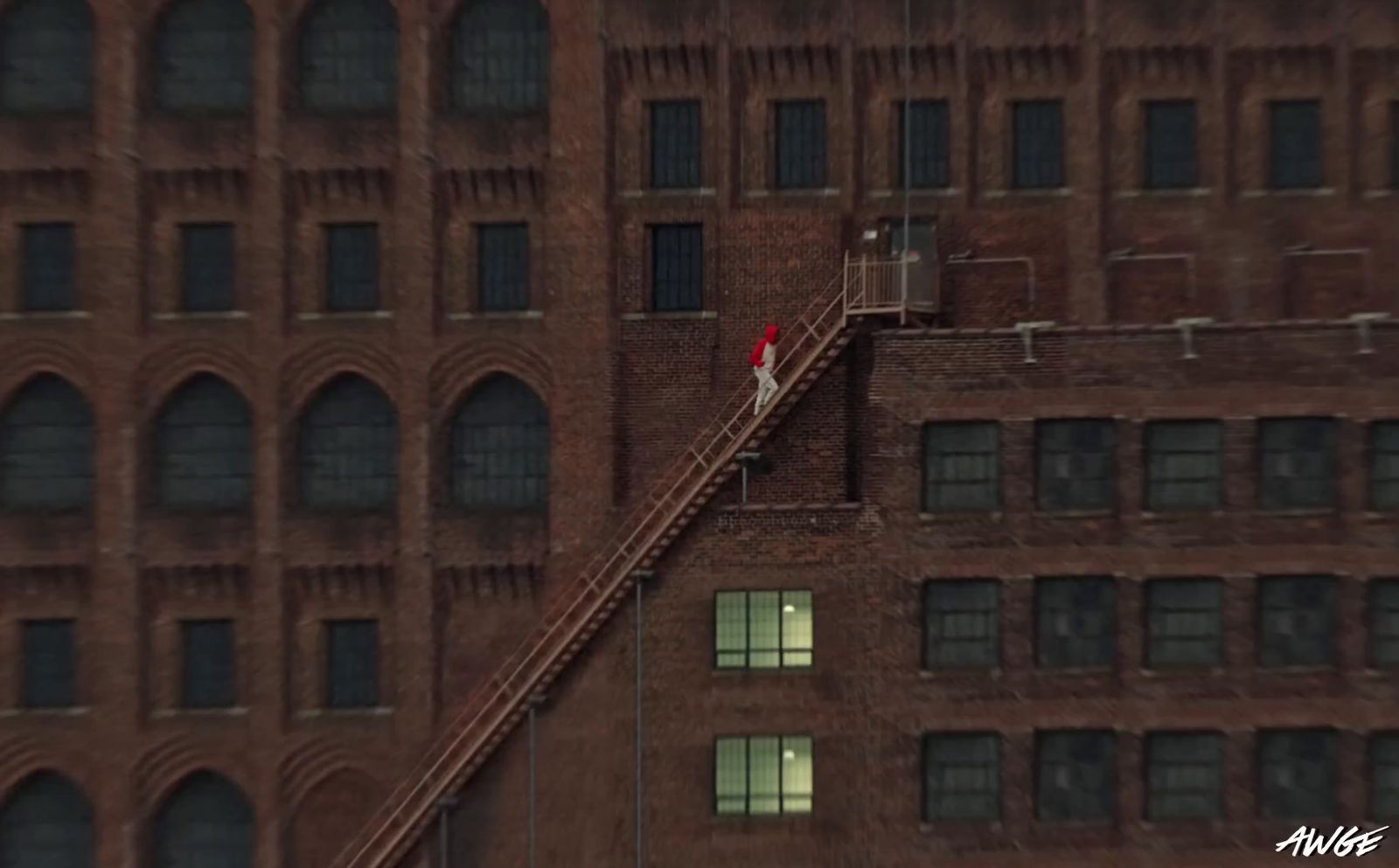 a person walking up a set of stairs in front of a brick building