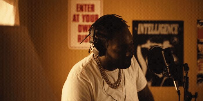 a man in a recording studio with a microphone