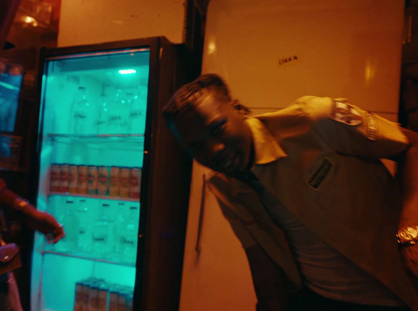 a man standing in front of a refrigerator