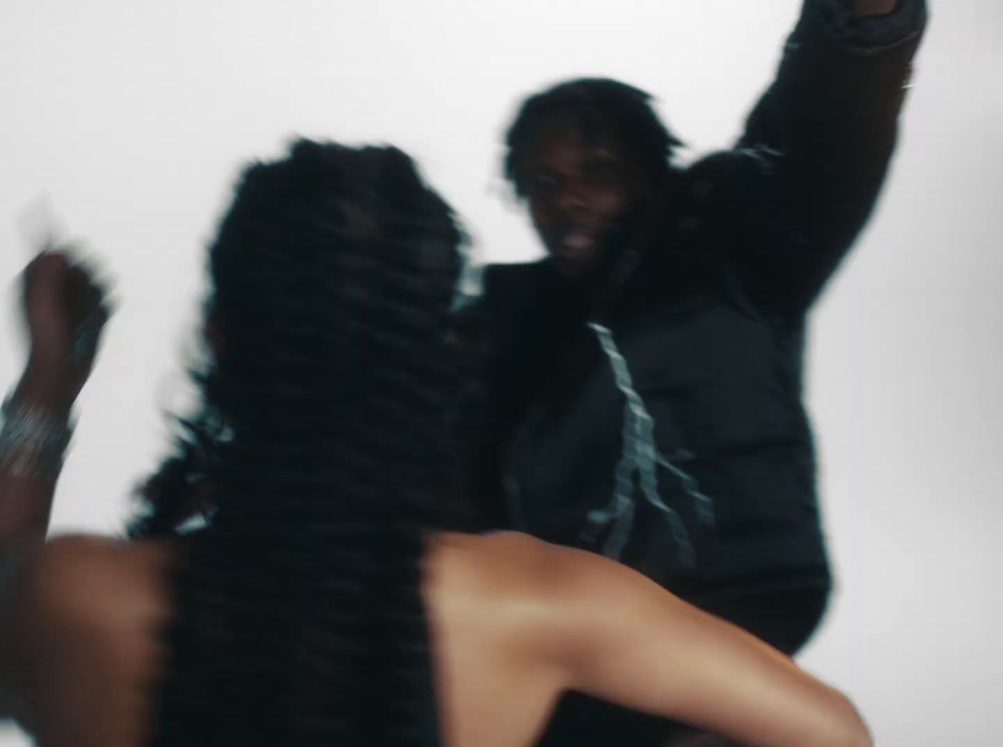 a blurry image of a man and a woman dancing