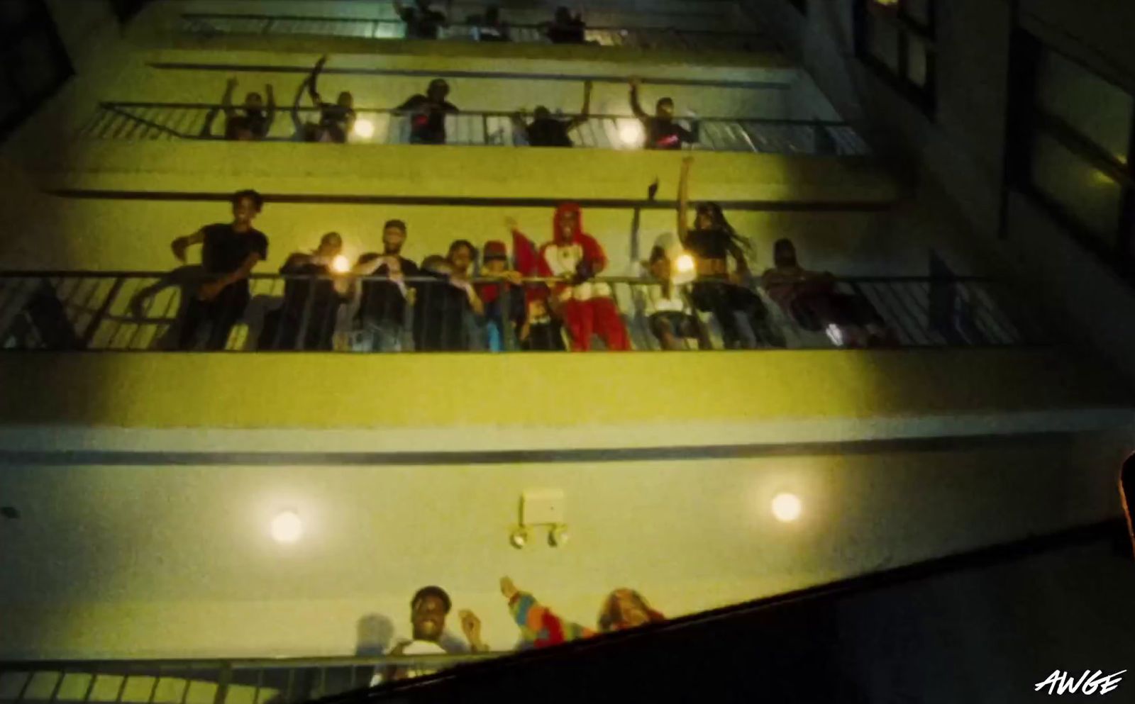 a group of people standing on a balcony at night