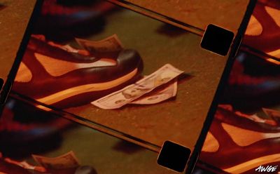 a pair of shoes sitting on top of a pile of money