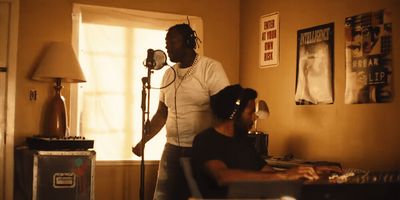 a man standing in front of a microphone in a living room