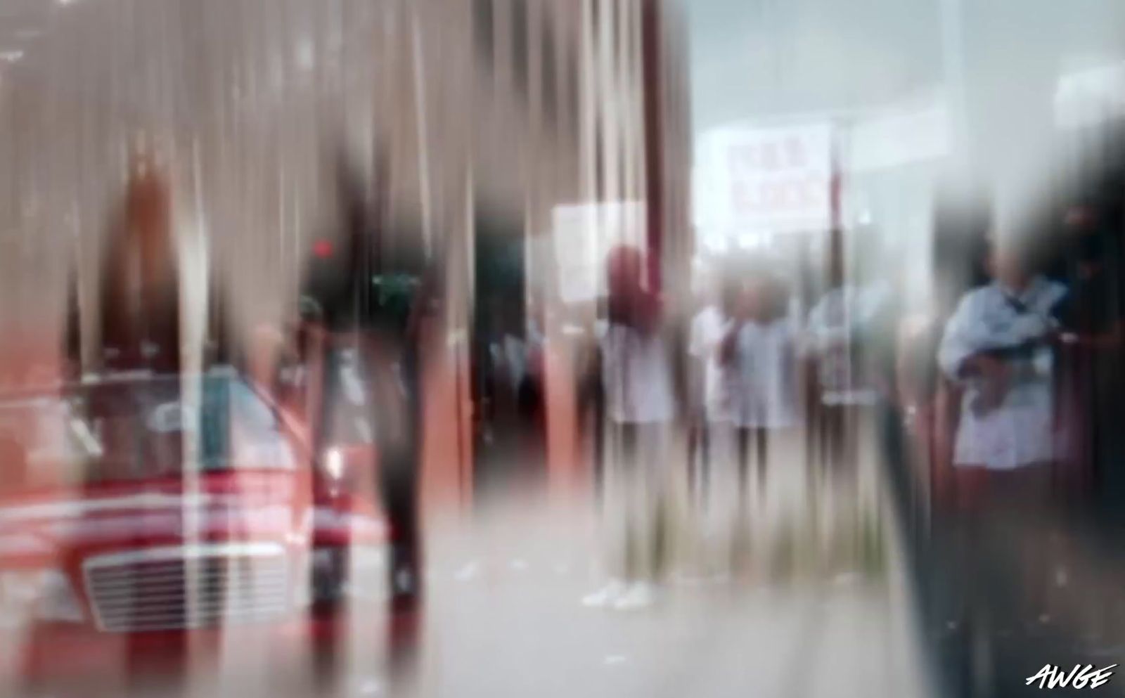 a blurry photo of a red car parked in front of a building