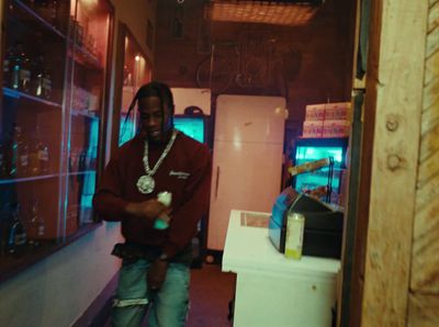 a man standing in front of a refrigerator in a kitchen