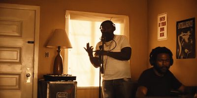 a man standing in a living room holding a microphone