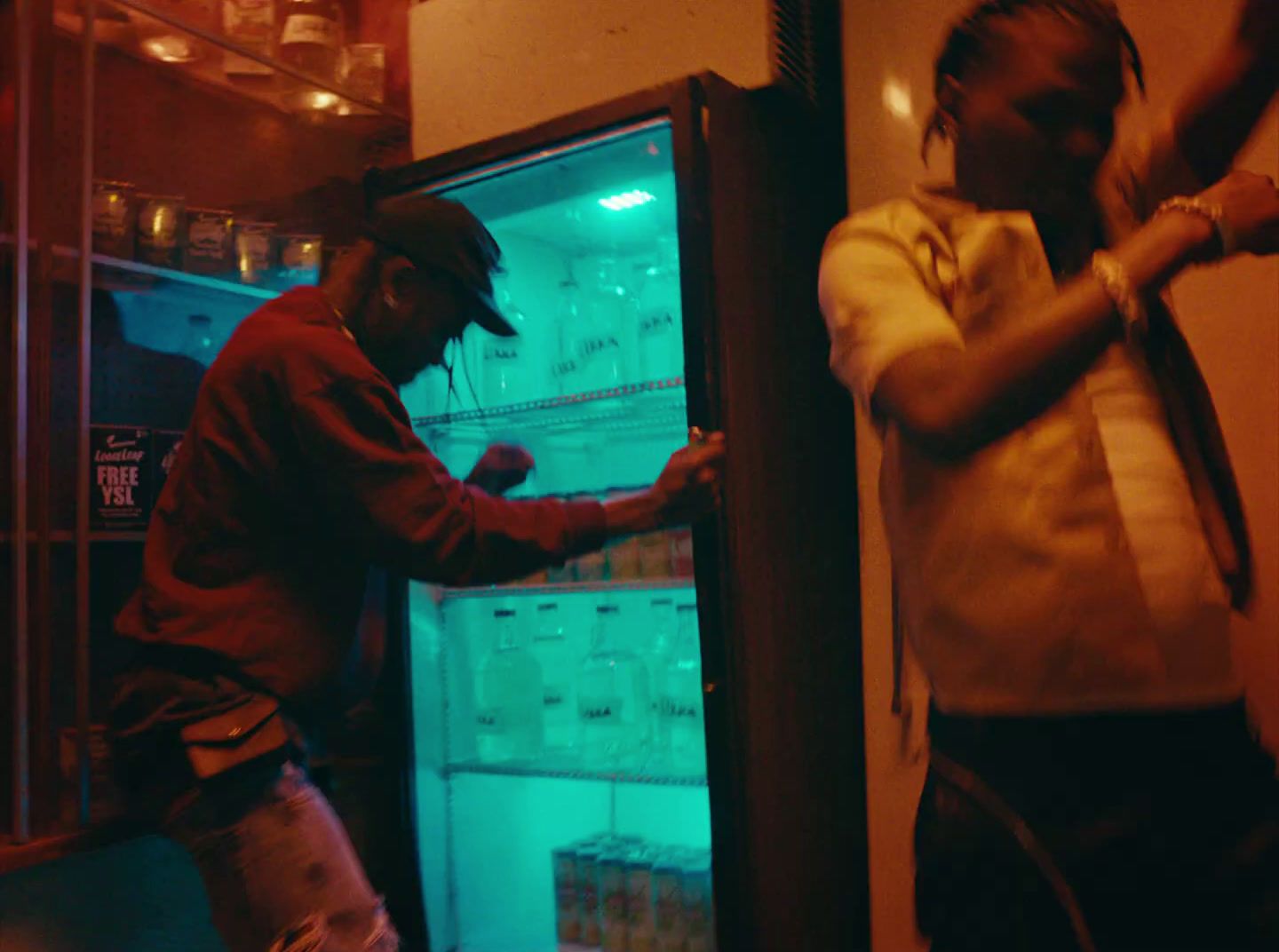 two men standing in front of an open refrigerator