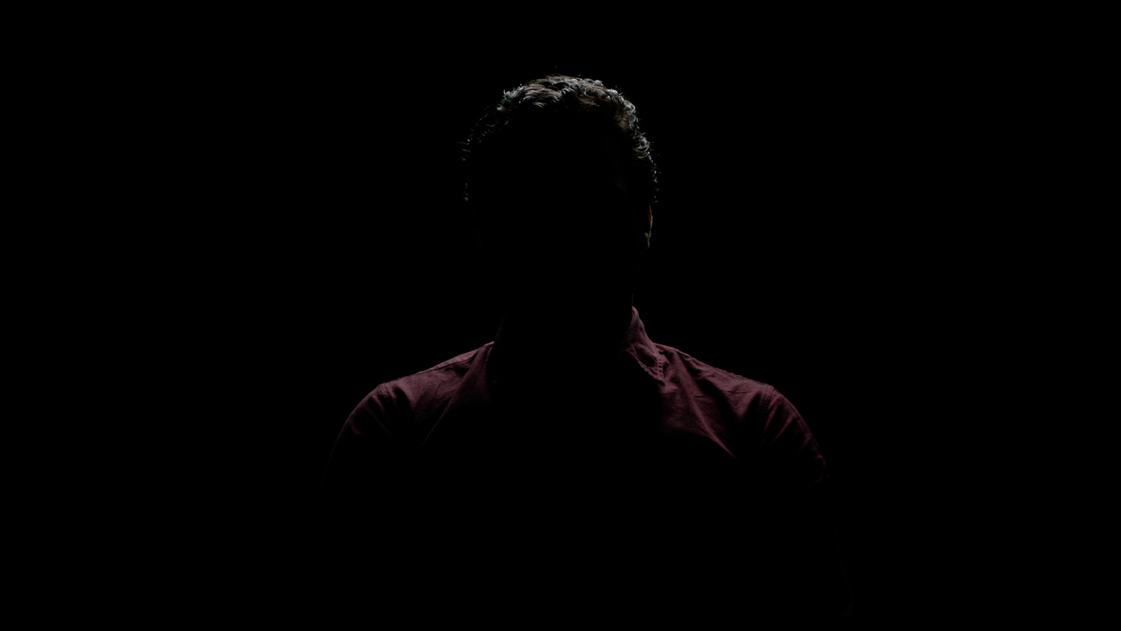 a silhouette of a person in the dark