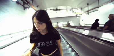 a woman standing on an escalator in an airport